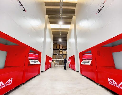 MAXI T automated tower storage for panels and sheet metal, feeding a laser cutting cell.